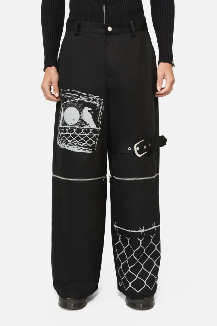 Image of a model wearing Pants. Productname: Murder Of Crows Zip Off Pant in Black colour by brand - Black Friday