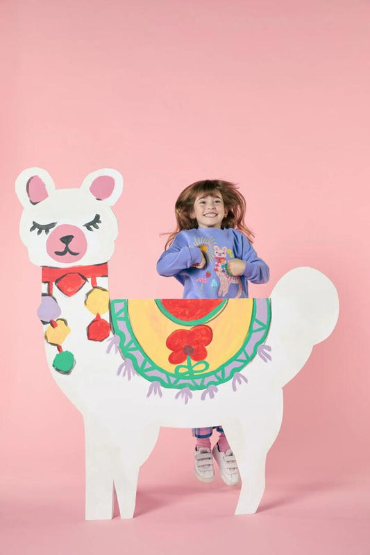 Image of a model wearing Outerwear. Productname: Pretty Llama Kids Sweater in Purple colour by brand - Princess Highway Kids