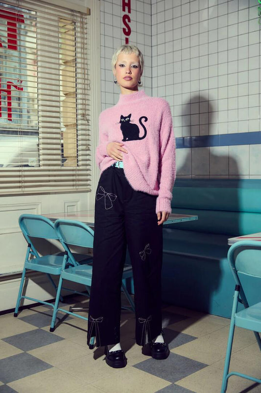 Image of a model wearing Pants. Productname: Catkins Bow Pants in Black colour by brand - Dangerfield