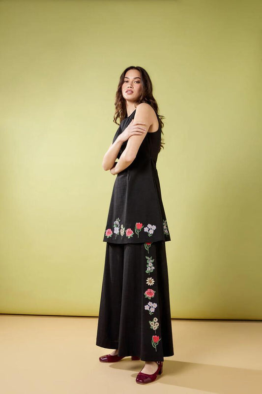 Image of a model wearing Pants. Productname: Fleur Embroidered Pant in Black colour by brand - Princess Highway