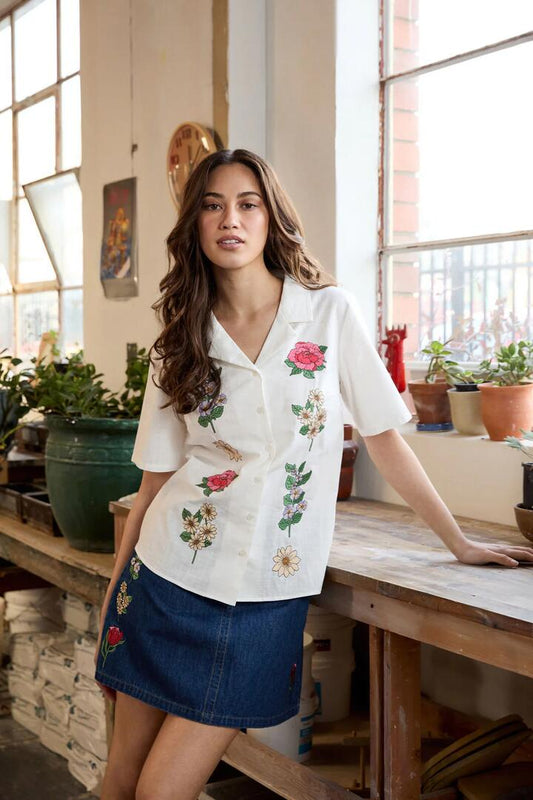 Image of a model wearing Tops. Productname: Fleur Embroidered Shirt in Cream colour by brand - Princess Highway