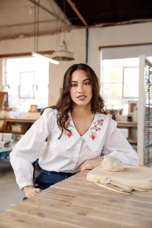 Image of a model wearing Tops. Productname: Folk Art Embroidered Blouse in White colour by brand - Princess Highway