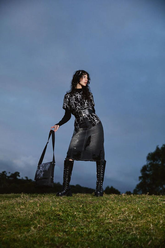 Image of a model wearing Denim. Productname: Sigil Distressed Denim Midi Skirt in Black colour by brand - Black Friday