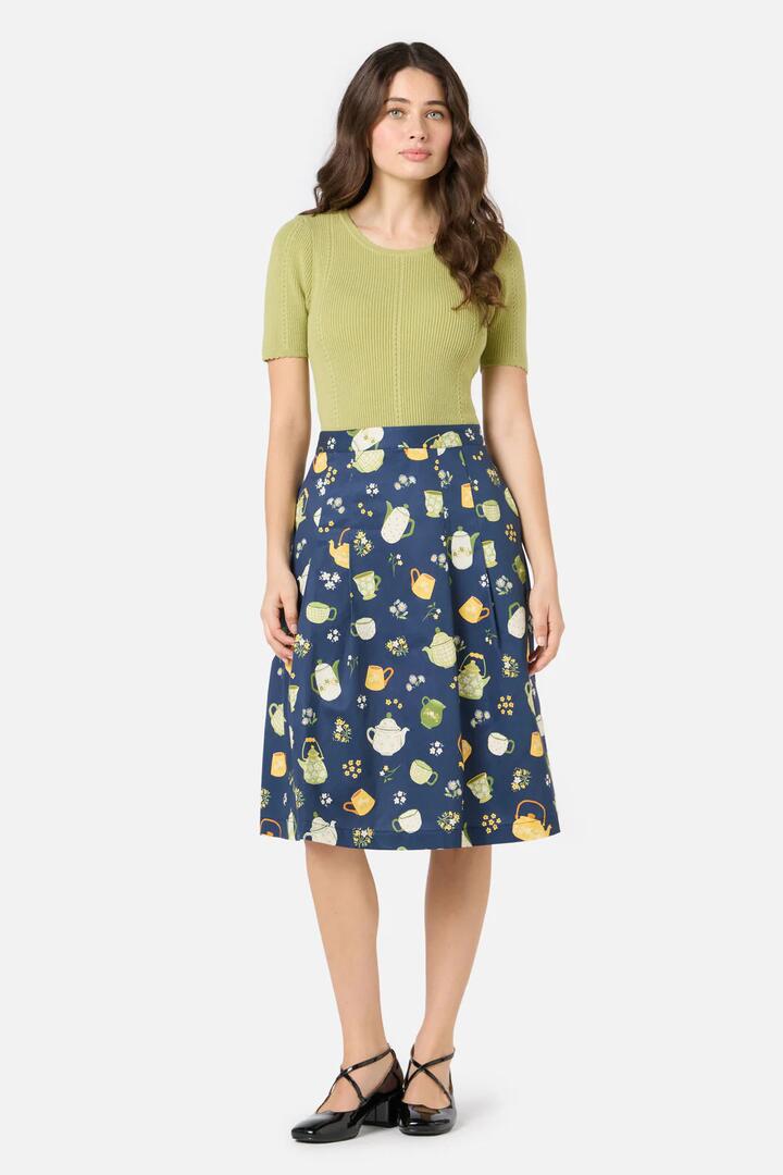 Image of a model wearing Skirts. Productname: Tea Time Pleat Skirt in Navy colour by brand - Princess Highway