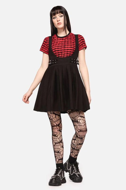 Image of a model wearing Dress. Productname: Defiant Punk Trim Pinafore in Black colour by brand - Dangerfield