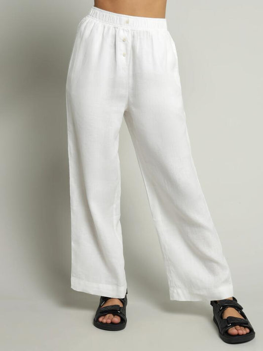 Image of a model wearing Pants. Productname: Nude Lucy Nude Lounge Linen Pants in White colour by brand - Nude Lucy