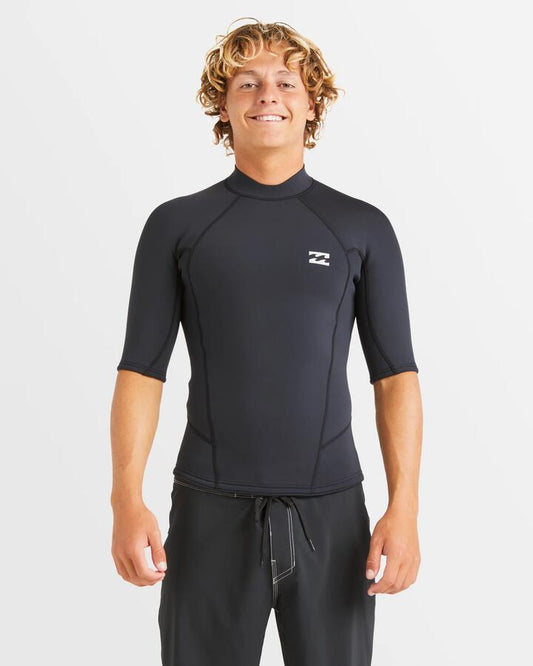 Image of a model wearing Tops. Productname: Billabong Mens Absolute Short Sleeve Surf Wetsuit Top Black - in Black colour by brand - Billabong