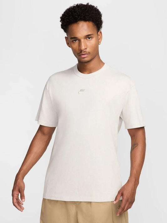 Image of a model wearing Tops. Productname: Nike Premium Essentials T-Shirt in Light Bone/Heather colour by brand - Nike