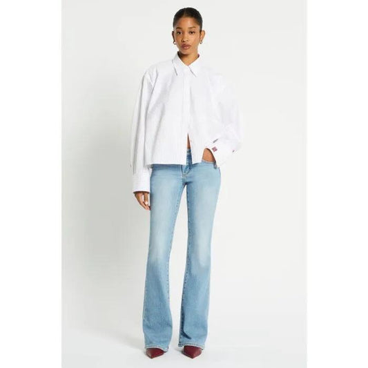 Image of a model wearing Denim. Productname: Vintage Low Rise Bootleg Jean in Washed Indigo colour by brand - sass and bide
