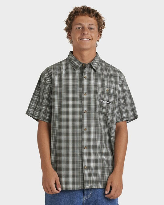 Image of a model wearing Tops. Productname: Billabong Mens Spec Mogul Short Sleeve Shirt Dark Forest - in Dark Forest colour by brand - Billabong