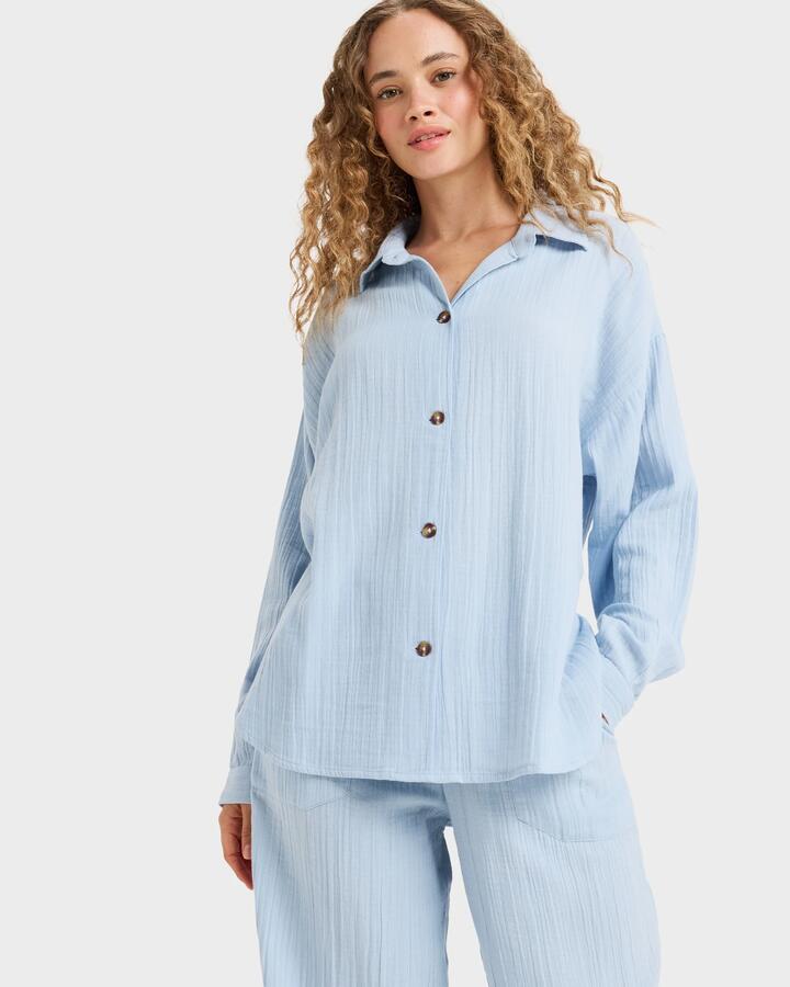 Image of a model wearing Tops. Productname: Roxy - Womens Morning Time Long Sleeve Shirt - Kentucky Blue - in Kentucky Blue colour by brand - Roxy