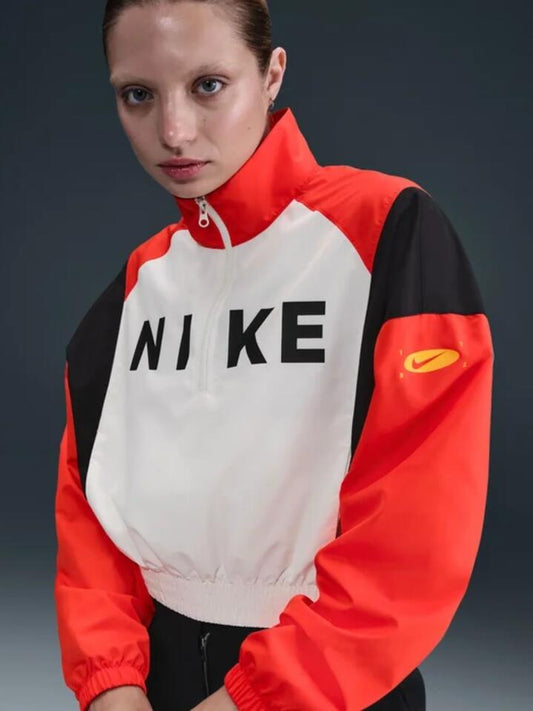 Image of a model wearing Outerwear. Productname: Nike NSW Woven Lightweight 1/4-Zip Jacket in Sail/Picante Red/Black colour by brand - Nike