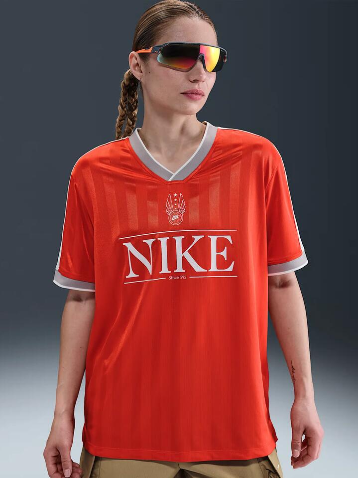 Image of a model wearing Tops. Productname: Nike NSW V-Neck Jersey Top in Pcnte Rd/Sl/Mdnt Nvy/Sl colour by brand - Nike