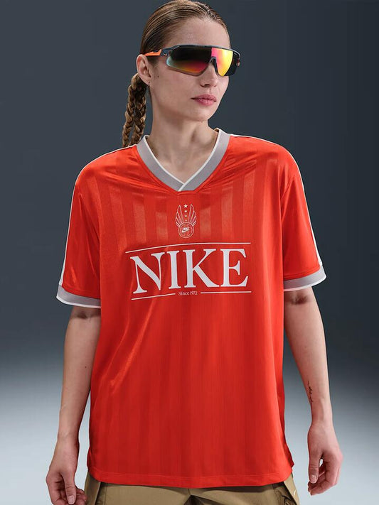 Image of a model wearing Tops. Productname: Nike NSW V-Neck Jersey Top in Pcnte Rd/Sl/Mdnt Nvy/Sl colour by brand - Nike