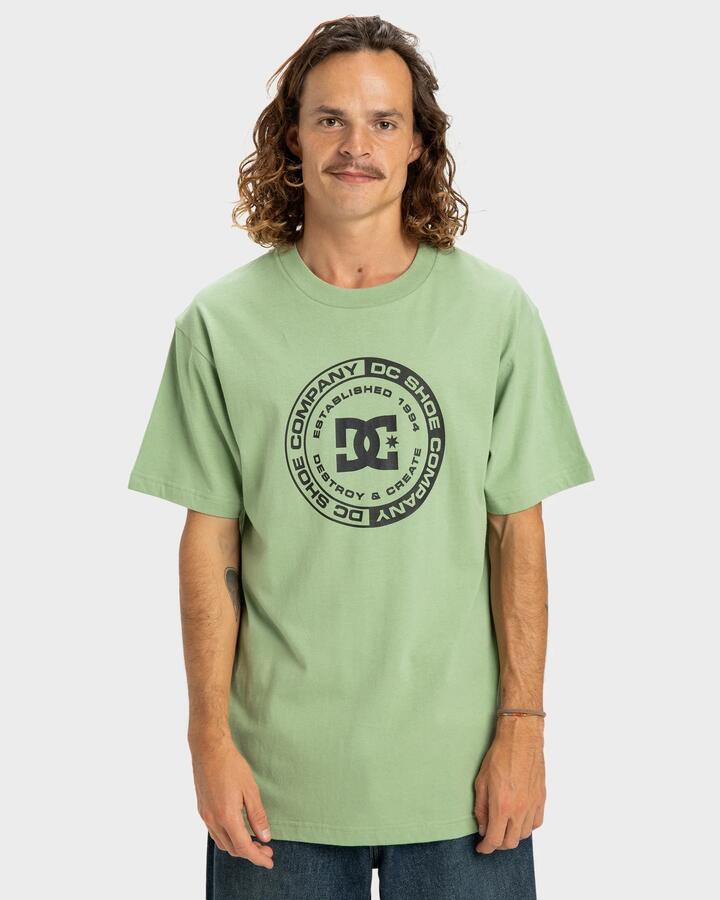 Image of a model wearing Tops. Productname: DC Shoes - Mens Dc Corpo T-Shirt - Basil - in Basil colour by brand - DC Shoes