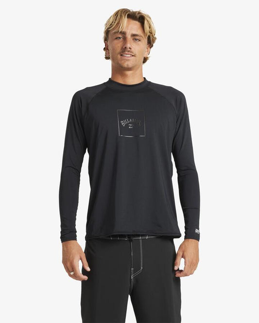 Image of a model wearing Tops. Product name - Billabong Mens Boxed Arch Long Sleeve Rash Vest Stealth in Stealth colour by brand - Billabong