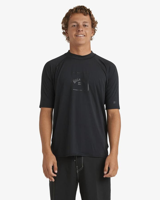 Image of a model wearing Tops. Productname: Billabong Mens Boxed Arch Short Sleeve Rash Vest Stealth - in Stealth colour by brand - Billabong