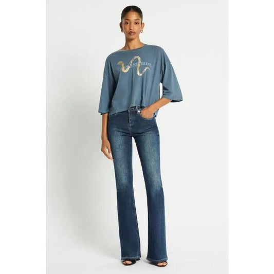 Image of a model wearing Denim. Productname: Vintage Mid Rise Bootleg Jean in Indigo colour by brand - sass and bide