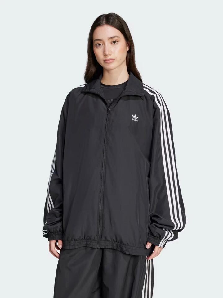 Image of a model wearing Tops. Productname: Adidas Adilenium Season 3 Oversized Track Top in Black colour by brand - Adidas
