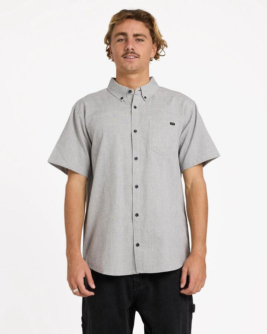 Image of a model wearing Tops. Product name - Billabong Mens All Day Short Sleeve Shirt Light Grey in Light Grey colour by brand - Billabong