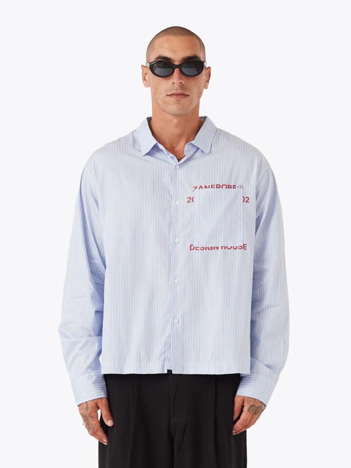 Image of a model wearing Tops. Productname: Zanerobe Overlap Crop Ls Shirt in Blue Stripe colour by brand - Zanerobe