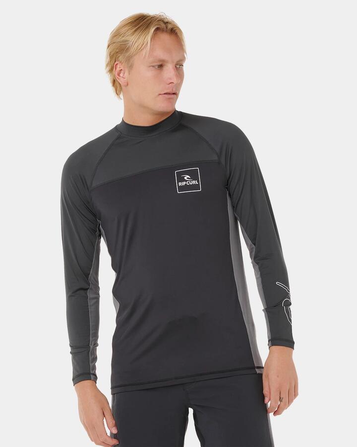 Image of a model wearing Tops. Product name - Rip Curl Mens Drive Upf Long Sleeve Rash Vest Black in Black colour by brand - Rip Curl