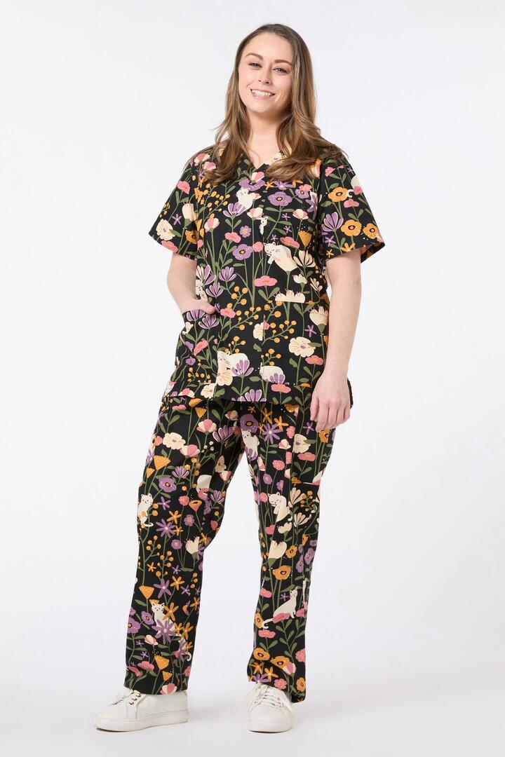 Image of a model wearing Uniforms & Workwear. Productname: Zoe Cat Scrub Set in Black colour by brand - Scrubs With Love