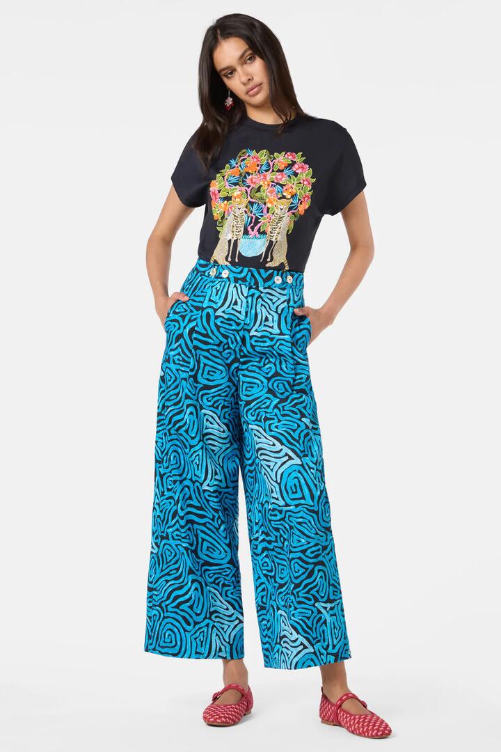 Image of a model wearing Pants. Product name - Swirl Harvest Pant in Print colour by brand - Gorman