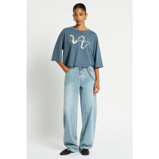 Image of a model wearing Tops. Productname: Indiana Cropped Tee in Washed Indigo colour by brand - sass and bide