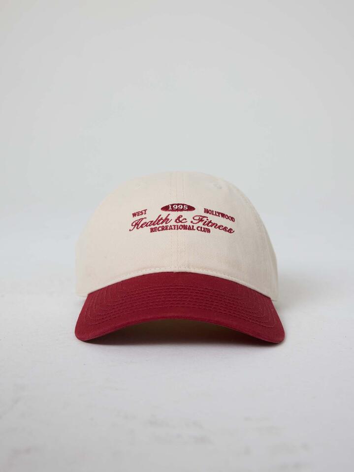 Image of Hats. Productname: West Hollywood Sweat Club Health and Fitness Two Tone Ball Park Cap ONE SIZE IVORY WINE in IVORY WINE colour by brand - West Hollywood Sweat Club