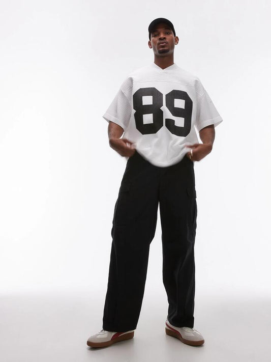 Image of a model wearing Pants. Productname: Topman Wide Leg Cargo Pants in Black colour by brand - Topman