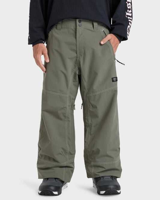 Image of a model wearing Pants. Productname: Quiksilver Mens Live Wire Snow Pants Dusty Olive - in Dusty Olive colour by brand - Quiksilver