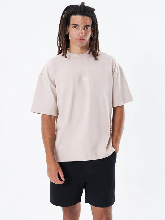 Image of a model wearing Tops. Productname: Article One Script Logo Tee in Oat colour by brand - Article One