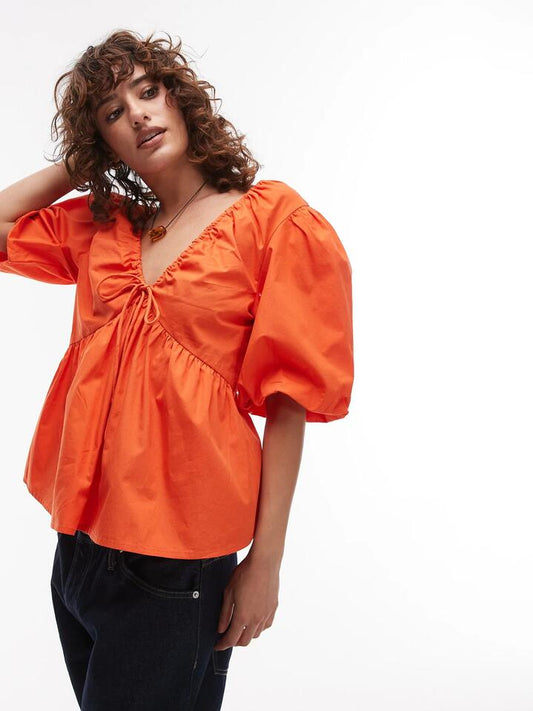 Image of a model wearing Tops. Productname: Topshop Poplin Puff Sleeve Top in Orange colour by brand - Topshop