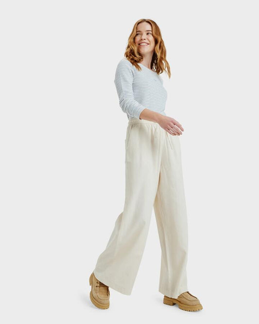 Image of a model wearing Pants. Productname: Roxy - Womens Lekeitio Break Mid Elastic Waist Pants - Parchment - in Parchment colour by brand - Roxy