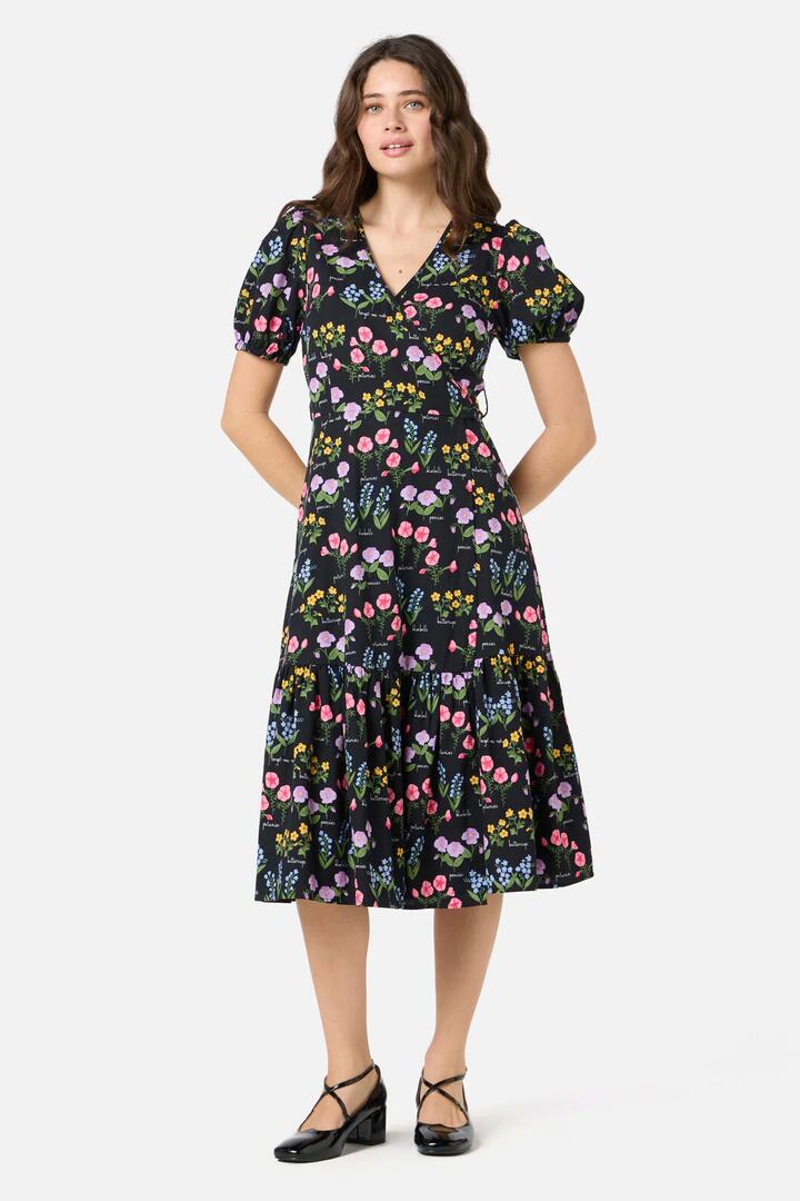 Image of a model wearing Dress. Productname: Cottage Garden Midi Wrap Dress in Black colour by brand - Princess Highway