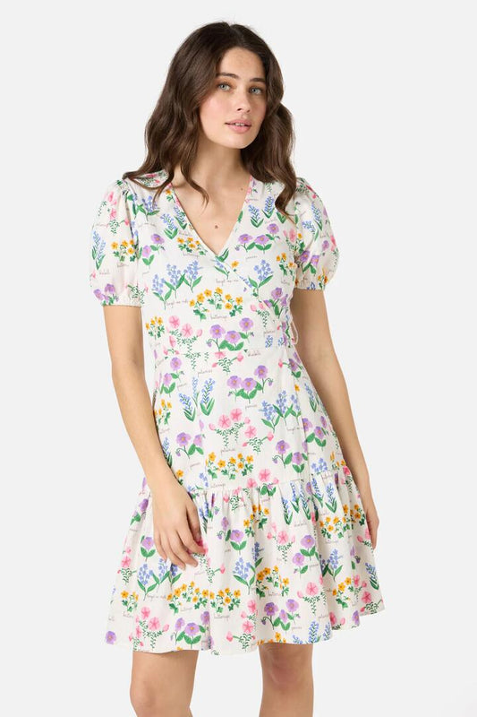 Image of a model wearing Dress. Productname: Cottage Garden Mini Wrap Dress in Cream colour by brand - Princess Highway
