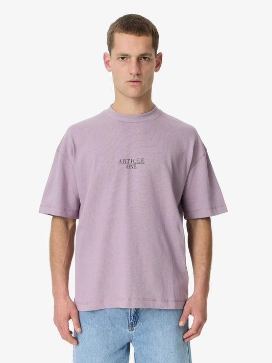 Image of a model wearing Tops. Productname: Article One Nice Serif Tee in Lavender colour by brand - Article One