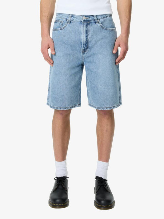 Image of a model wearing Denim. Productname: Article One Bertie Jean Short in Indigo colour by brand - Article One