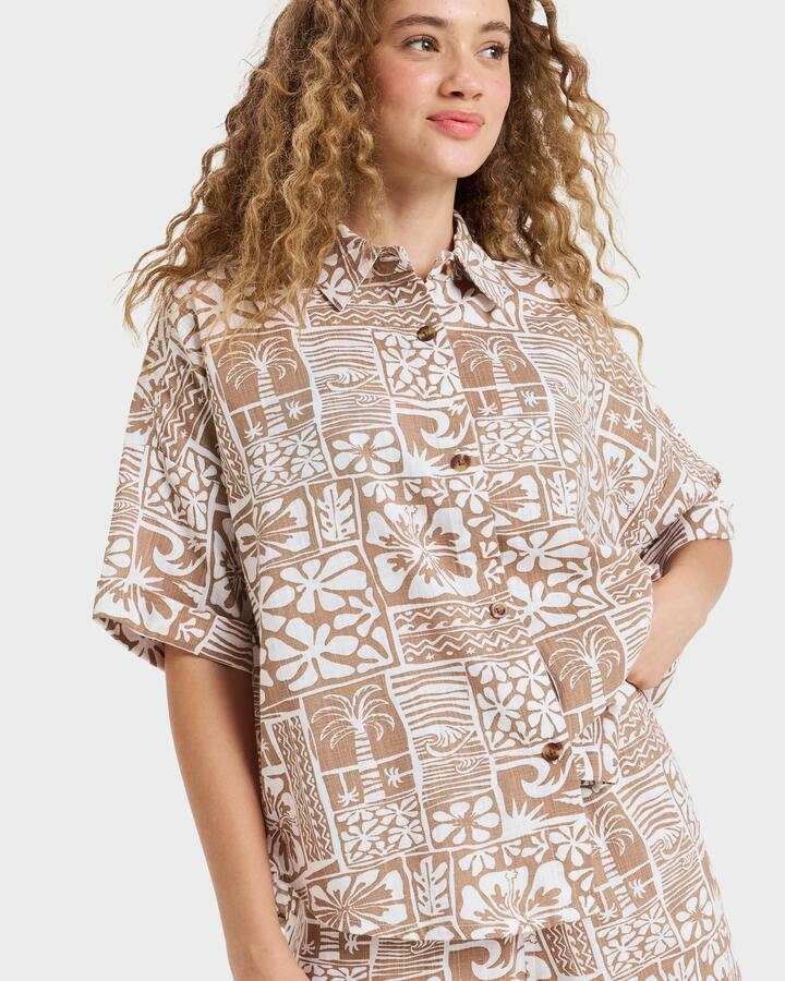 Image of a model wearing Tops. Product name - Roxy Womens Beachy Nostalgia Slub Short Sleeve Shirt Woodsmoke Surfenirs in Woodsmoke Surfenirs colour by brand - Roxy
