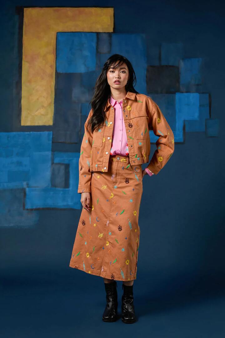 Image of a model wearing Skirts. Product name - Desert Garden Denim Midi Skirt in Print colour by brand - Gorman