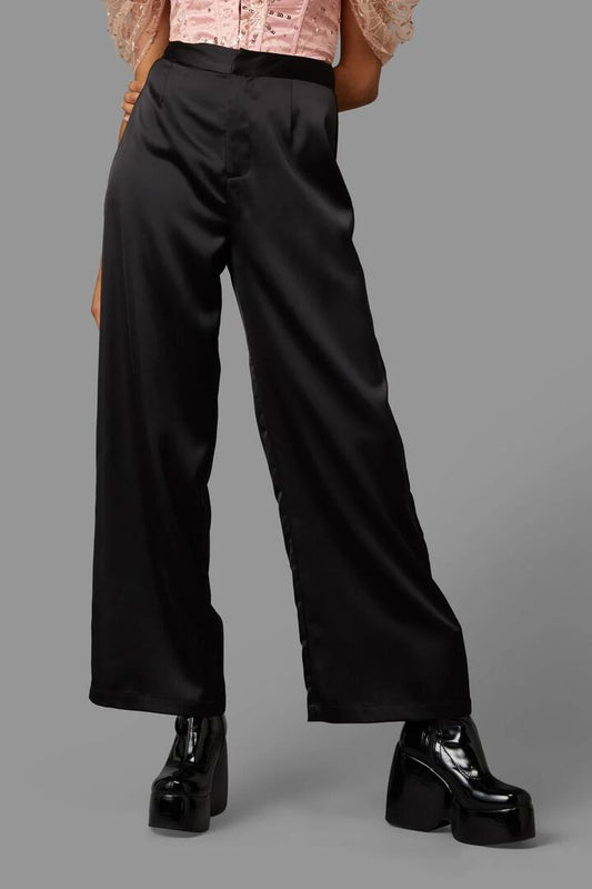 Image of a model wearing Pants. Product name - Enid Pant in Gold colour by brand - Black Friday