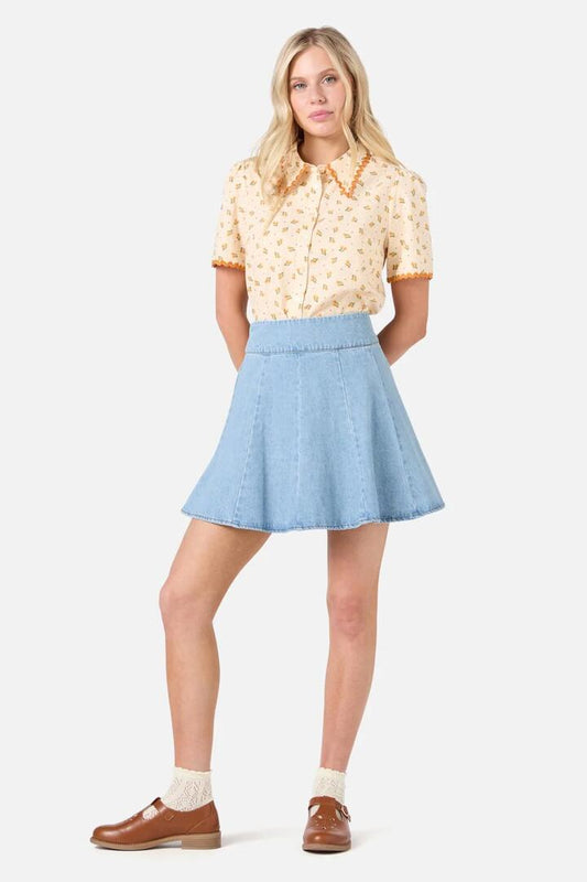 Image of a model wearing Skirts. Productname: Clara Denim Mini Skirt in Light Blue Denim colour by brand - Princess Highway