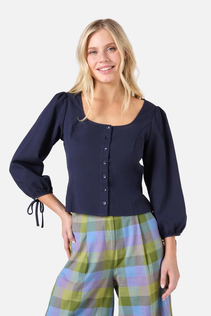 Image of a model wearing Tops. Productname: Layla Puff Sleeved Top in Navy colour by brand - Princess Highway