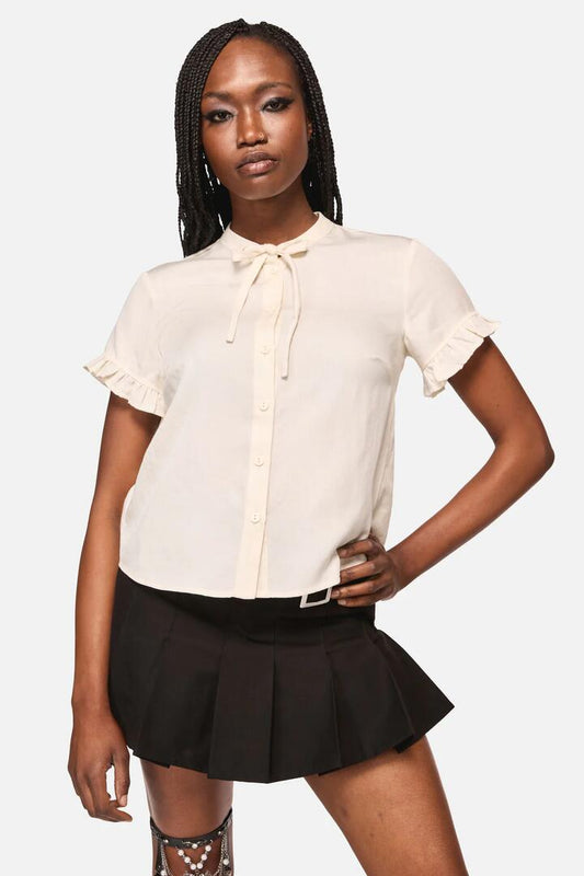 Image of a model wearing Tops. Productname: Crypt Bow SS Blouse in Cream colour by brand - Black Friday