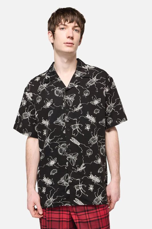 Image of a model wearing Shorts. Productname: Dark Pieridae Short Sleeve Shirt in Black colour by brand - Dangerfield