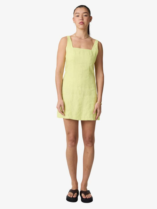Image of a model wearing Dress. Productname: Lulu & Rose Margot Mini Dress in Chartreuse colour by brand - Lulu & Rose