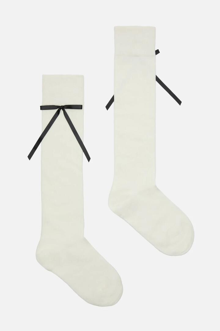 Image of Socks. Productname: White Knee High Rib Bow Sock in White colour by brand - Princess Highway