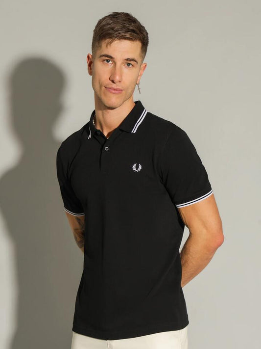 Image of a model wearing Tops. Productname: Fred Perry Twin Tipped Polo T-Shirt in Black/White colour by brand - Fred Perry
