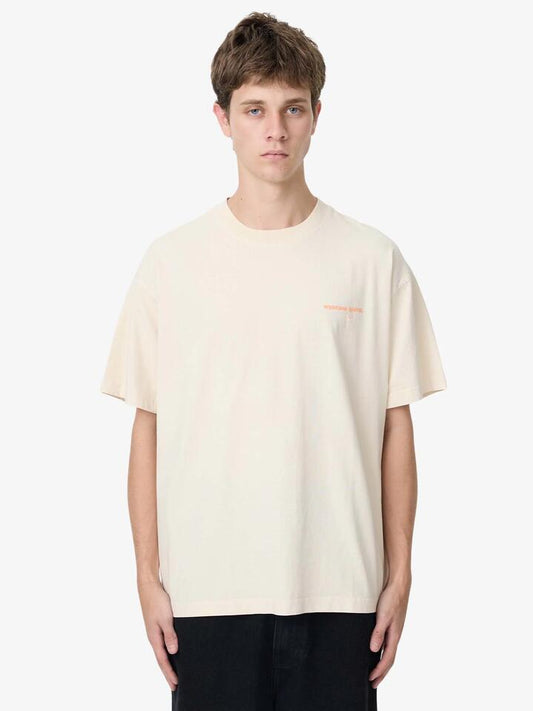 Image of a model wearing Tops. Productname: Weekend Cartel History Tee in Oat colour by brand - Weekend Cartel